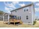 Backyard view featuring deck, grill, and a screened porch at 104 Chaseford Ct, Holly Springs, NC 27540