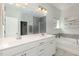 This stylish bathroom offers double sinks, a soaking tub, and a separate glass-enclosed shower at 104 Chaseford Ct, Holly Springs, NC 27540