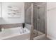 This contemporary bathroom features a soaking tub and separate shower with glass enclosure and stylish tile at 104 Chaseford Ct, Holly Springs, NC 27540