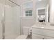 Well-lit bathroom featuring a glass door shower and bright window at 104 Chaseford Ct, Holly Springs, NC 27540