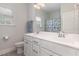 Bright bathroom with double vanity, sleek white cabinets, and a window providing natural light for a refreshing feel at 104 Chaseford Ct, Holly Springs, NC 27540