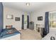 This cute bedroom features a fun space-themed bed and decor and two windows with natural light at 104 Chaseford Ct, Holly Springs, NC 27540