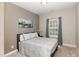 Comfortable bedroom featuring plush carpet, soothing neutral colors, and natural light from a window at 104 Chaseford Ct, Holly Springs, NC 27540