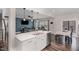 Open-concept kitchen with white cabinetry, stainless steel appliances, and spacious island overlooking the living room at 104 Chaseford Ct, Holly Springs, NC 27540