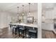 Stylish kitchen with stainless steel appliances, white cabinets, and a view to dining and living area at 104 Chaseford Ct, Holly Springs, NC 27540