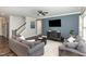 Comfortable living room with modern decor, hardwood floors, and plenty of natural light streaming through the windows at 104 Chaseford Ct, Holly Springs, NC 27540