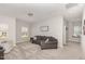Bright living room with plush seating, large windows, and neutral tones creates a cozy and inviting space at 104 Chaseford Ct, Holly Springs, NC 27540