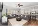 Bright living room features hardwood floors, neutral paint, and open layout to kitchen and dining area at 104 Chaseford Ct, Holly Springs, NC 27540
