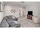 Comfortable living room with plush seating, a TV, and neutral tones provides an inviting and relaxing space at 104 Chaseford Ct, Holly Springs, NC 27540