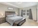 This spacious main bedroom features a tray ceiling, large window, and stylish decor for a relaxing retreat at 104 Chaseford Ct, Holly Springs, NC 27540