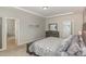 The spacious main bedroom leads to an ensuite bath and features stylish decor and a comfortable king-sized bed at 104 Chaseford Ct, Holly Springs, NC 27540