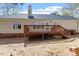 Back exterior with a wooden deck accessible by stairs, offering a perfect spot for relaxation and outdoor gatherings at 105 Damask Rose Dr, Holly Springs, NC 27540