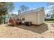 The backyard presents a wooden deck accessible by stairs, with adequate yard space at 105 Damask Rose Dr, Holly Springs, NC 27540