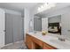 A bathroom with double sinks and a shower and a mirror to a bedroom at 105 Damask Rose Dr, Holly Springs, NC 27540