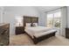 Nicely decorated bedroom with a large bed, carpet, and lots of light at 105 Damask Rose Dr, Holly Springs, NC 27540