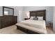 Nicely decorated bedroom with a large bed, carpet, and dresser at 105 Damask Rose Dr, Holly Springs, NC 27540