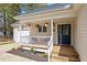 Charming front porch with white railings and hanging plants, adding character to this lovely home at 105 Damask Rose Dr, Holly Springs, NC 27540