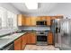Spacious kitchen featuring stainless steel appliances, ample cabinets, and a functional layout at 105 Damask Rose Dr, Holly Springs, NC 27540