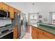Bright kitchen boasts stainless appliances, wood cabinets, and breakfast bar at 105 Damask Rose Dr, Holly Springs, NC 27540