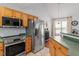 Functional kitchen featuring stainless steel appliances and access to the dining area at 105 Damask Rose Dr, Holly Springs, NC 27540