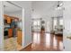 Open-concept living space with hardwood floors connecting to a kitchen featuring stainless steel appliances and wood cabinets at 105 Damask Rose Dr, Holly Springs, NC 27540