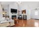 Bright living room featuring hardwood floors, a fireplace, and modern decor at 105 Damask Rose Dr, Holly Springs, NC 27540