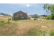 Spacious backyard with a large, grassy area and view of neighboring homes in the community at 1102 Dartmouth Dr, Mebane, NC 27302