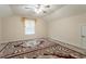 Neutral bedroom with a ceiling fan, dormer window and an ornate patterned rug at 1102 Dartmouth Dr, Mebane, NC 27302