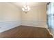 Traditional dining room featuring hardwood floors, wainscoting, and an elegant chandelier at 1102 Dartmouth Dr, Mebane, NC 27302