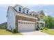 Stylish home features a blend of stone and siding, with a two-car garage and covered porch at 1102 Dartmouth Dr, Mebane, NC 27302