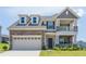 Charming two-story home featuring a stone facade, two-car garage and welcoming front porch at 1102 Dartmouth Dr, Mebane, NC 27302