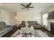 Cozy living room featuring a ceiling fan and view of the fireplace at 1102 Dartmouth Dr, Mebane, NC 27302