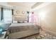Large main bedroom featuring decorative wall mirrors, a large bed, and bright natural light at 1102 Dartmouth Dr, Mebane, NC 27302
