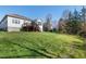 Large backyard with a deck, sunroom, and views of mature trees and lush green grass at 11129 Bayberry Hills Dr, Raleigh, NC 27617