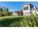 Spacious backyard featuring a multi-level deck, enclosed porch, and lush green lawn at 11129 Bayberry Hills Dr, Raleigh, NC 27617