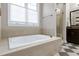 This bathroom features a soaking tub with tile surround and a separate glass-enclosed shower at 11129 Bayberry Hills Dr, Raleigh, NC 27617