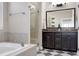 The bathroom provides a double sink vanity with dark cabinetry and a glass-enclosed shower at 11129 Bayberry Hills Dr, Raleigh, NC 27617