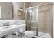 This bathroom is complete with a shower and vanity with a ceramic sink and white cabinets at 11129 Bayberry Hills Dr, Raleigh, NC 27617