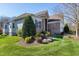 Charming home with stone accents, manicured landscaping, and a well-maintained lawn at 11129 Bayberry Hills Dr, Raleigh, NC 27617