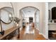 Inviting foyer featuring hardwood floors, arched doorway, console table, and view of the living area at 11129 Bayberry Hills Dr, Raleigh, NC 27617