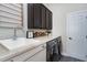 The laundry room features a sink, counter space, overhead cabinets, and front-loading washer and dryer at 11129 Bayberry Hills Dr, Raleigh, NC 27617