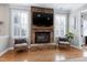 Inviting living room with a stone fireplace, hardwood floors, and comfortable armchairs at 11129 Bayberry Hills Dr, Raleigh, NC 27617
