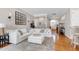 Bright living room features a comfortable, oversized white sectional and hardwood floors at 11129 Bayberry Hills Dr, Raleigh, NC 27617