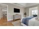 The main bedroom showcases a wall-mounted television, a dresser, and access to another room at 11129 Bayberry Hills Dr, Raleigh, NC 27617