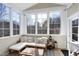 Cozy sunroom with lots of natural light and a comfy sectional at 11129 Bayberry Hills Dr, Raleigh, NC 27617