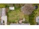Aerial view of backyard featuring shed, trampoline, garden beds, and brick home with deck at 1208 Briarcliff Rd, Burlington, NC 27215