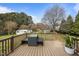 Wooden deck with outdoor seating, overlooking lush backyard and shed at 1208 Briarcliff Rd, Burlington, NC 27215