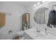 Bathroom featuring a vanity, a round mirror, and decorative storage cabinet at 1208 Briarcliff Rd, Burlington, NC 27215