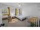 Cozy bedroom featuring a crib, chair, and generous natural light from windows at 1208 Briarcliff Rd, Burlington, NC 27215