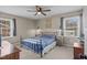 Comfortable bedroom with carpet, a ceiling fan, and good natural light from two windows at 1208 Briarcliff Rd, Burlington, NC 27215